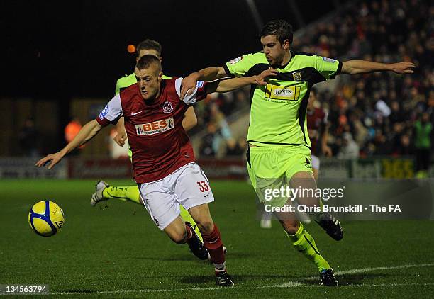 Jamie Vardy of Fleetwood Town competes with Paul Huntington of Yeovil Town during the FA Cup sponsored by Budweiser Second Round match between...