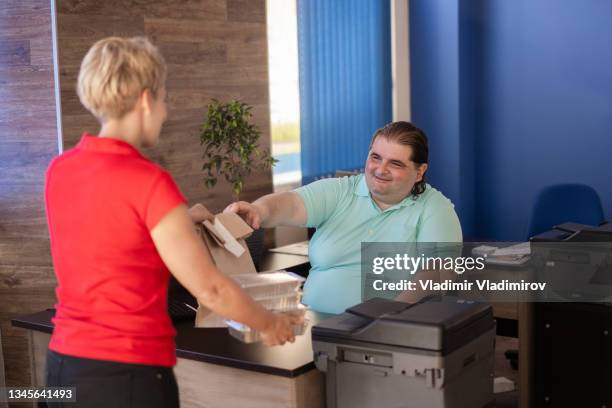 a delivery courier with a take away lunch - large printer stock pictures, royalty-free photos & images