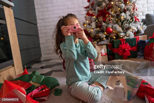 with her toy camera, she got for christmas, excited girl imitating that she making a photography - children camera stock pictures, royalty-free photos & images