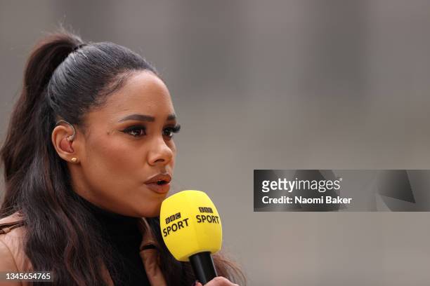 Presenter and former football player Alex Scott speaks prior to the Barclays FA Women's Super League match between Manchester United Women and...