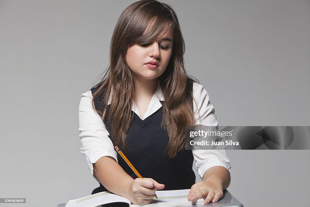 Schoolgirl studying on desk