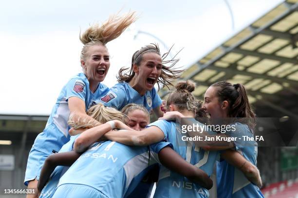 Khadija Shaw of Manchester City celebrates with teammates after scoring their team's first goal during the Barclays FA Women's Super League match...