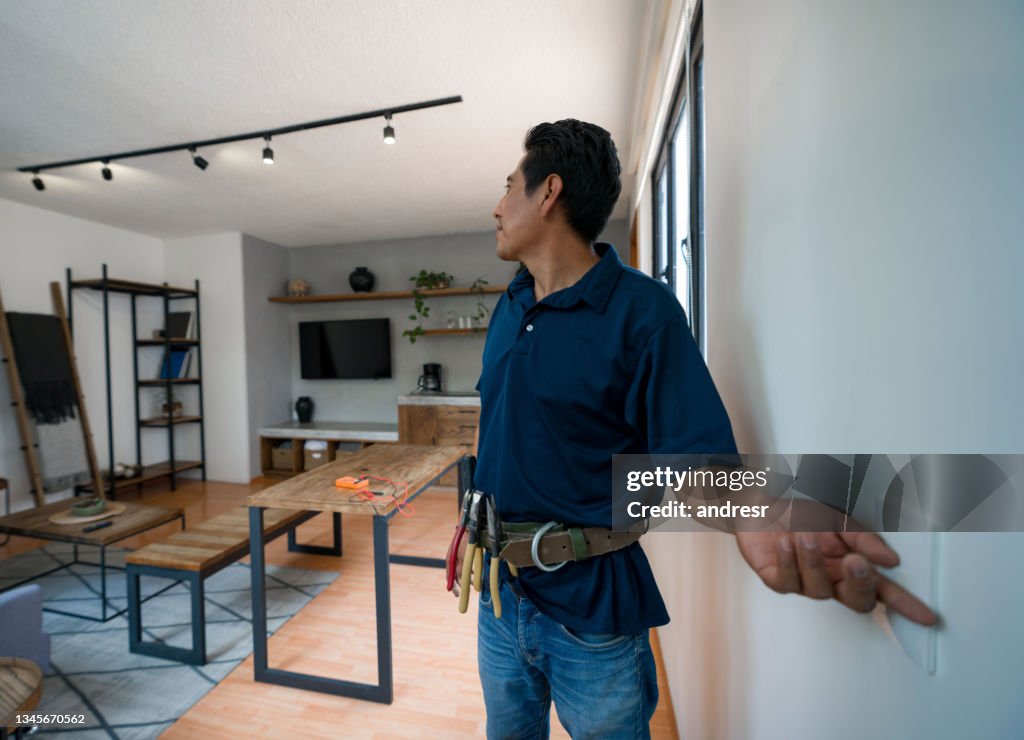 Electrician installing a dimmer to control the lights at a house