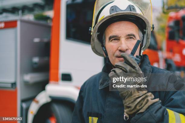 firefighter using walkie talkie - fireman stock pictures, royalty-free photos & images