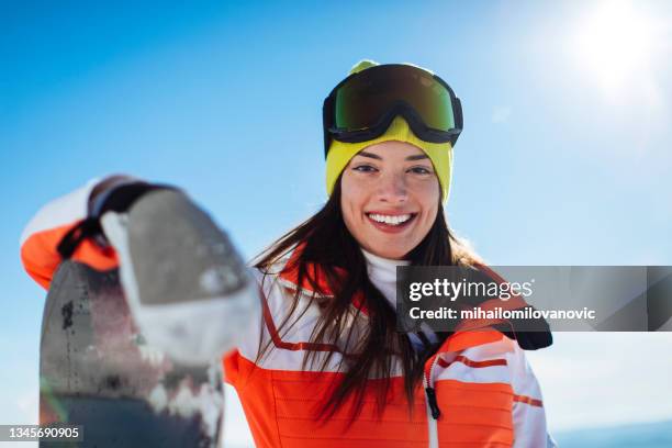 sun, snow and a smile - female skier stock pictures, royalty-free photos & images