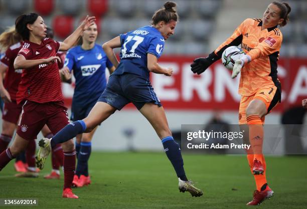Laura Benkarth of Bayern Munich saves a header from Franziska Harsch of Hoffenheim during the Frauen Bundesliga match between FC Bayern Munich and...