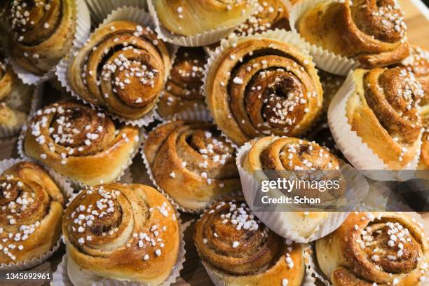 a collection of freshly baked cinnamon buns - sweet bun stock pictures, royalty-free photos & images