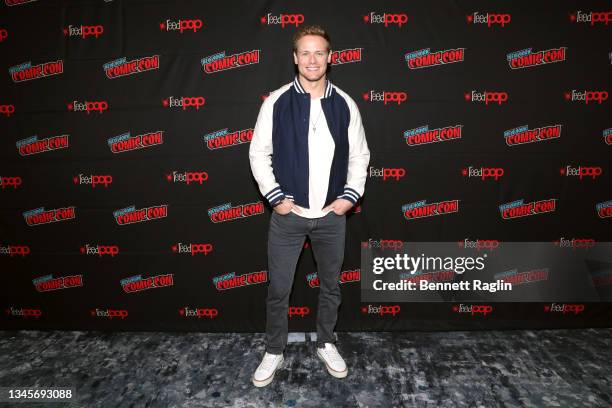 Sam Heughan poses for a photo op during the Outlander panel during Day 3 of New York Comic Con 2021 at Jacob Javits Center on October 09, 2021 in New...