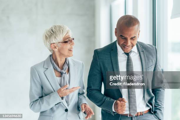 zwei fröhliche geschäftsleute - business people having meeting in modern office stock-fotos und bilder