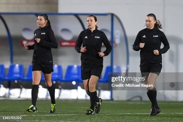 The all female match official team of Referee, Kateryna Monzul and assistants Maryna Striletska and Svitlana Grushko warm up before the 2022 FIFA...