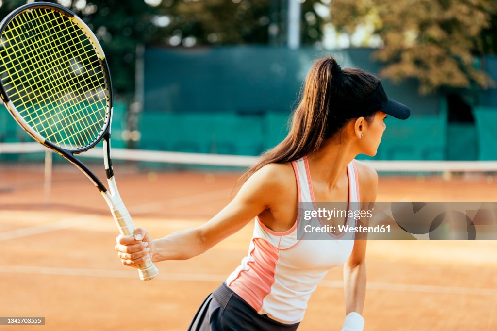 Female sportsperson playing tennis at sports court
