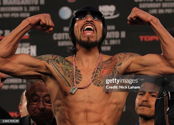 Antonio Margarito of Mexico flexes as he takes the scale for his bout with Miguel Cotto of Puerto Rico during their weigh in at The Theater at...