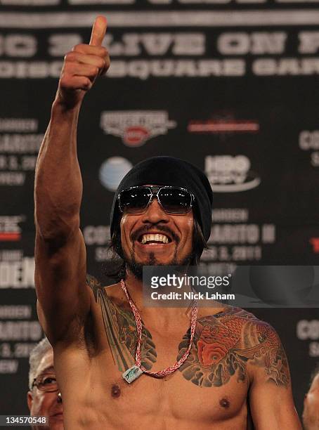 Antonio Margarito of Mexico gestures as he takes the scale for his bout with Miguel Cotto of Puerto Rico during their weigh in at The Theater at...