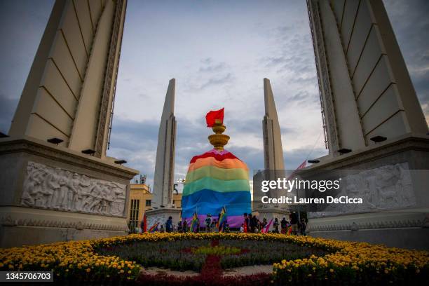 Giant rainbow flag is draped over Democracy Monument on October 9, 2021 in Bangkok, Thailand. The Feminist's Liberation Front is a democratic reform...