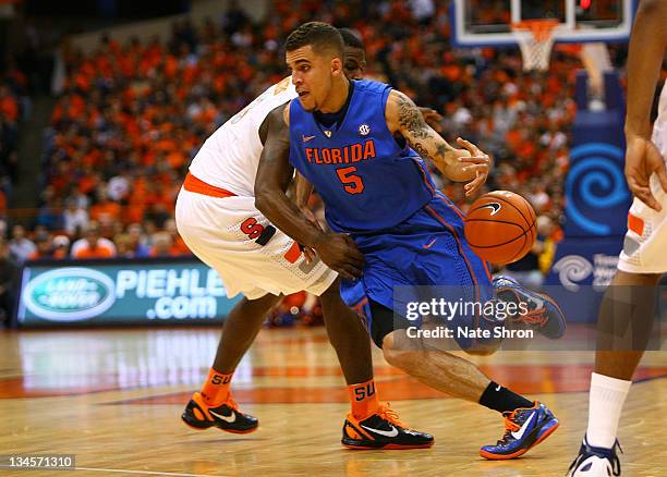 Scottie Wilbekin of the Florida Gators loses the ball as he drives down the court against Dion Waiters of the Syracuse Orange during the game at the...