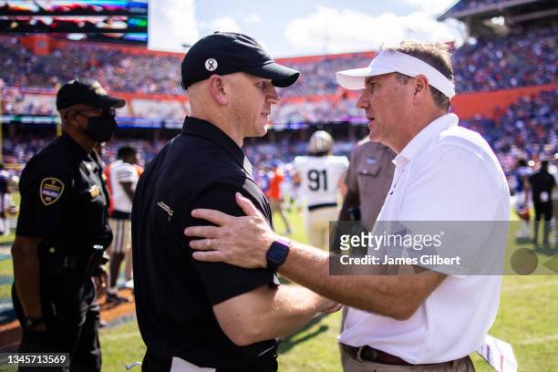 Head coach Clark Lea of the Vanderbilt Commodores meets with head coach Dan Mullen of the Florida Gators after a game at Ben Hill Griffin Stadium on...