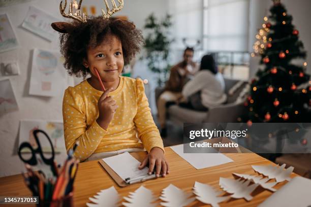 kleines mädchen, das einen brief an den weihnachtsmann schreibt - kinderwunsch stock-fotos und bilder