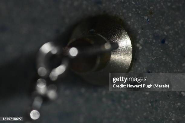 abstract metallic silver & gold objects - sink plug stock pictures, royalty-free photos & images