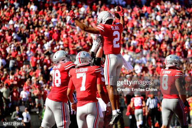 Teammates lift Chris Olave of the Ohio State Buckeyes after his touchdown in the third quarter during a game against the Maryland Terrapins at Ohio...