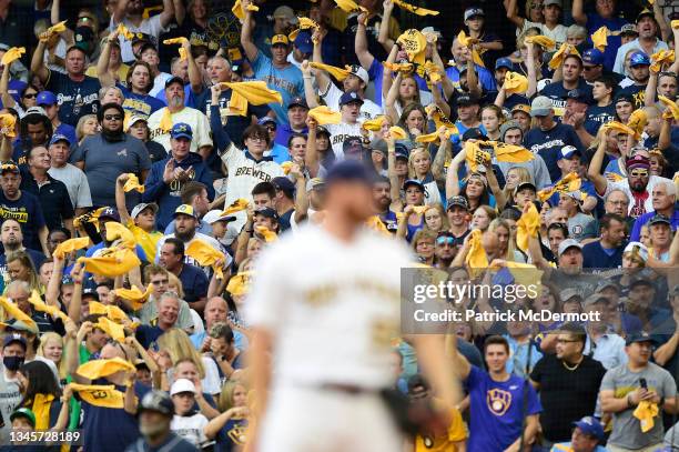 Milwaukee Brewers fans cheer on Brandon Woodruff of the Milwaukee Brewers before a pitch during game 2 of the National League Division Series against...