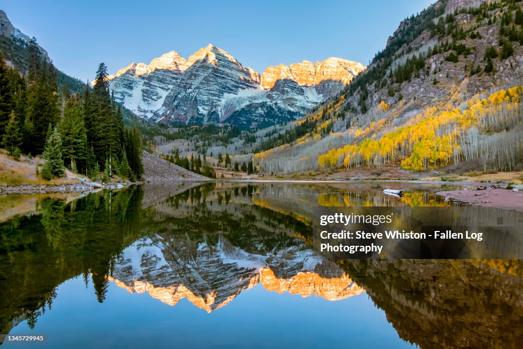 Snowcapped Maroon Bells Mountains With Reflection and Fall Foliage Aspen Colors at Sunrise