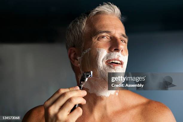 mature man shaving. - barbear imagens e fotografias de stock