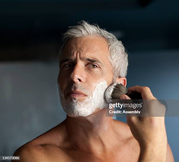 mature man lathering face before shaving - shaving brush - fotografias e filmes do acervo