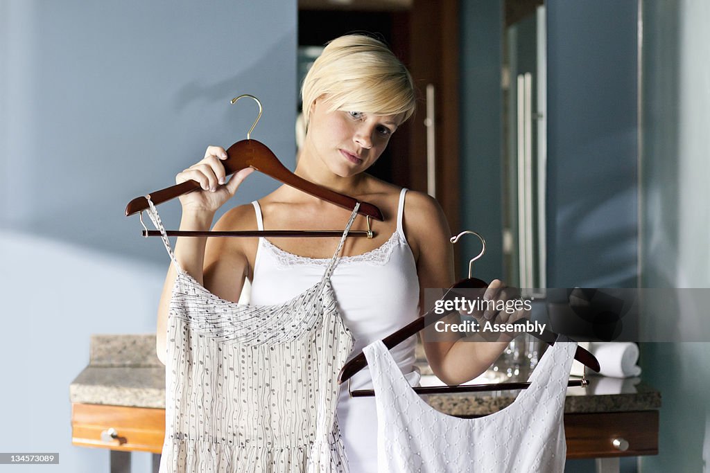 Woman choosing an outfit to wear.