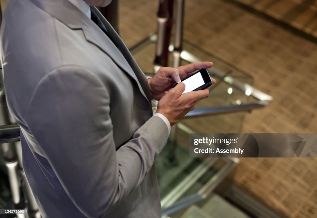 Mature businessman using smart phone.