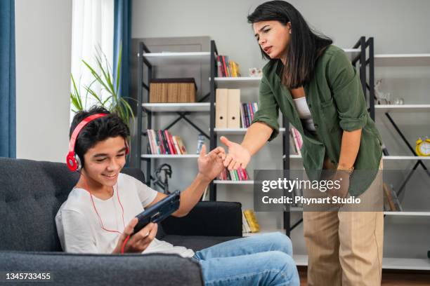 mother and her teenage son arguing at home - angry mom stock pictures, royalty-free photos & images