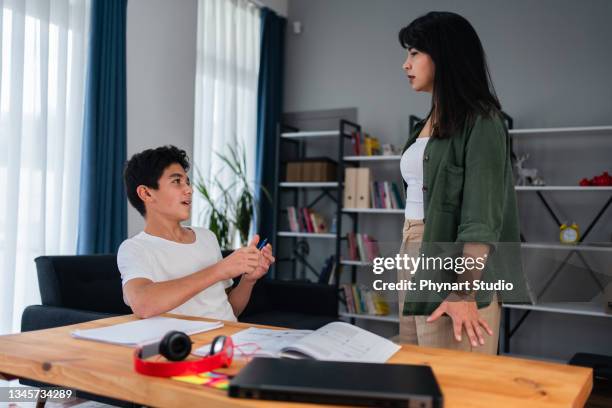 mother and her teenage son arguing at home - mother scolding stock pictures, royalty-free photos & images