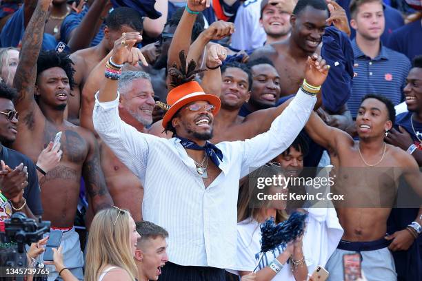 Former Auburn and NFL quarterback Cam Newton along with head men's basketball coach Bruce Pearl of the Auburn Tigers cheer with the fans prior to the...