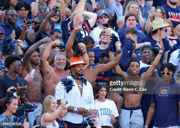 Former Auburn and NFL quarterback Cam Newton along with head men's basketball coach Bruce Pearl of the Auburn Tigers cheer with the fans prior to the...