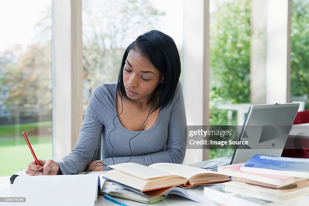 University student writing at desk