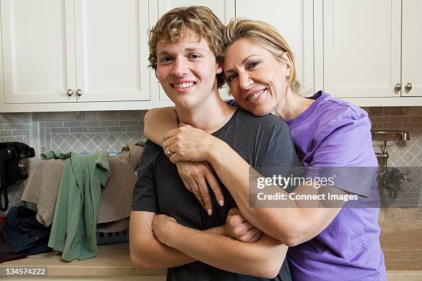 Mature Woman And Son In Laundry Room Portrait, Foto de stock