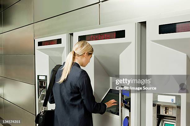 businesswoman buying a train ticket - ponytail stock pictures, royalty-free photos & images