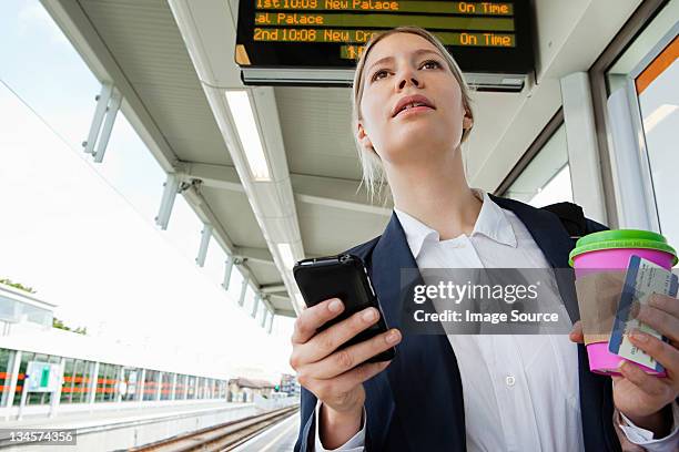 businesswoman in train station - immediate stock pictures, royalty-free photos & images