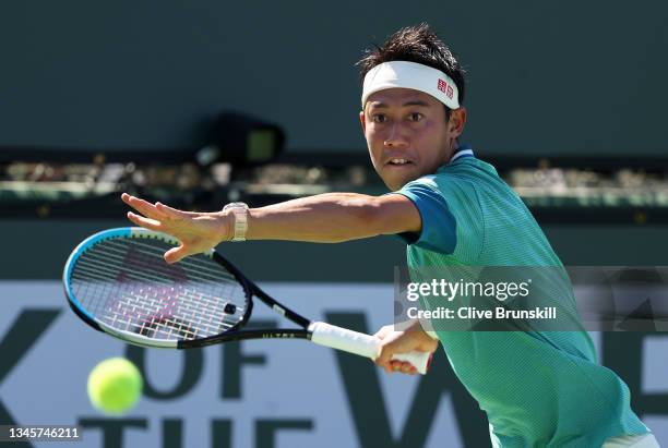 Kei Nishikori of Japan plays a forehand against Dan Evans of Great Britain during their second round match on Day 6 of the BNP Paribas Open at the...
