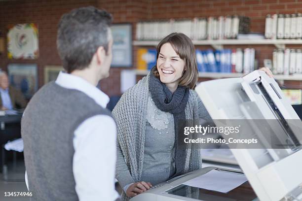 business people making copies at work - by the photocopier stock pictures, royalty-free photos & images