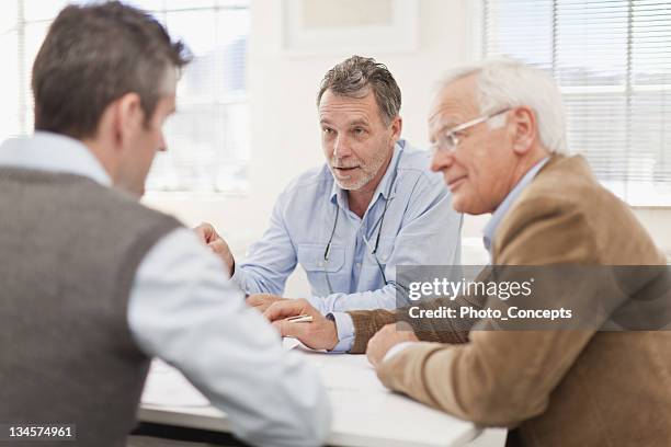 businessmen talking in meeting - business meeting three people stock pictures, royalty-free photos & images