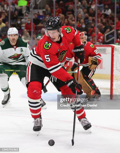 Connor Murphy of the Chicago Blackhawks controls the puck against the Minnesota Wild during a preseason game at the United Center on October 09, 2021...