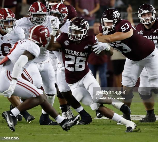 Isaiah Spiller of the Texas A&M Aggies rushes in the first half against the Alabama Crimson Tide at Kyle Field on October 09, 2021 in College...