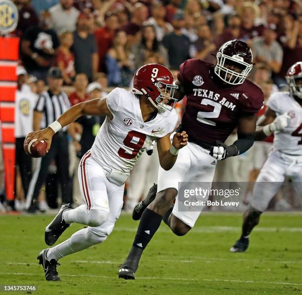 Bryce Young of the Alabama Crimson Tide is forced out of the Micheal Clemons of the Texas A&M Aggies at Kyle Field on October 09, 2021 in College...