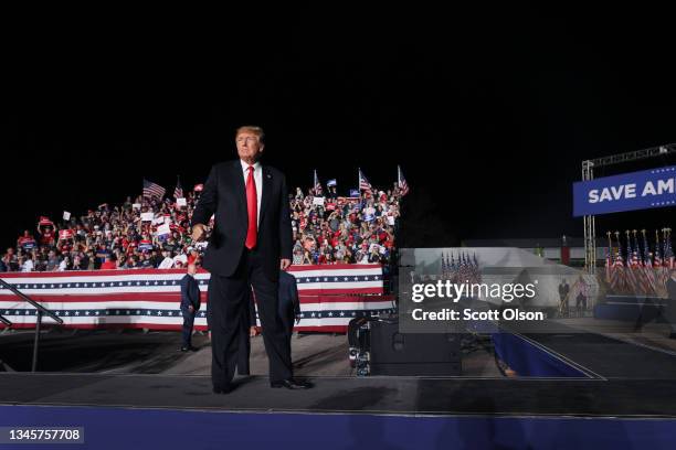 Former President Donald Trump leaves after speaking to supporters during a rally at the Iowa State Fairgrounds on October 09, 2021 in Des Moines,...