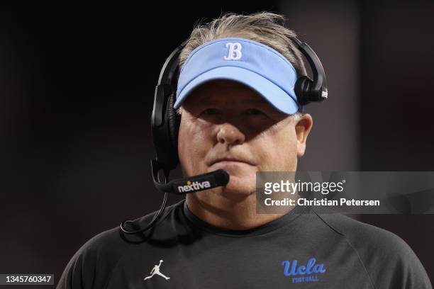 Head coach Chip Kelly of the UCLA Bruins walks the sidelines during the first half of the NCAAF game against the Arizona Wildcats at Arizona Stadium...