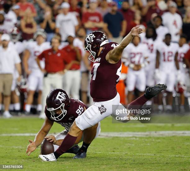 Seth Small of the Texas A&M Aggies kicks a 28 yard field goal out of the hold of Nik Constantinou to beat the Alabama Crimson Tide 41-38 at Kyle...