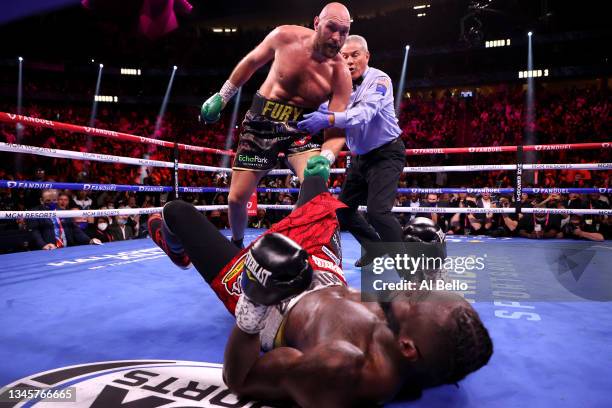 Deontay Wilder is knocked down by Tyson Fury in the third round of their WBC heavyweight title fight at T-Mobile Arena on October 09, 2021 in Las...