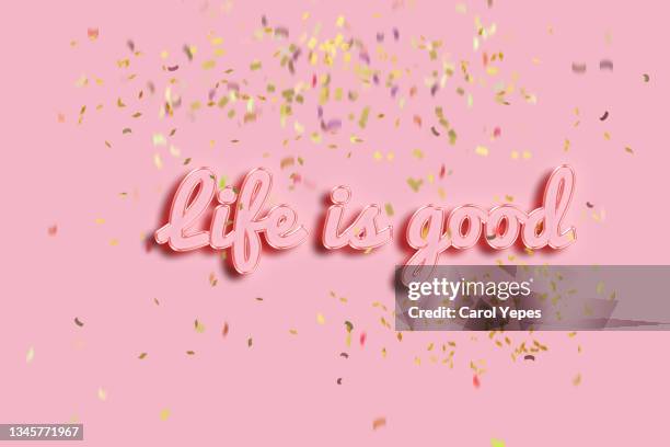 life is good quote in pink background with confetti - positive sayings stock pictures, royalty-free photos & images