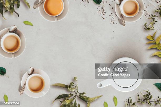 flat lay coffee and tea still life with green leaves.frame.grey background - porcelain background stock pictures, royalty-free photos & images