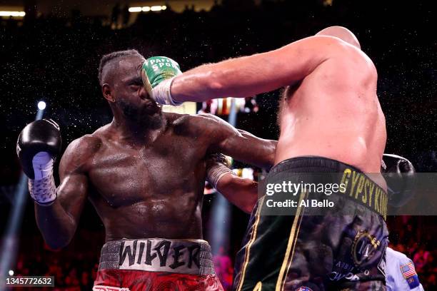 Tyson Fury punches Deontay Wilder during their WBC heavyweight title fight at T-Mobile Arena on October 09, 2021 in Las Vegas, Nevada.